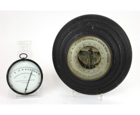 A Holosteric aneroid barometer, silvered dial, moulded ebonised circular frame, 25cm; and a tin cased relative percentage hum