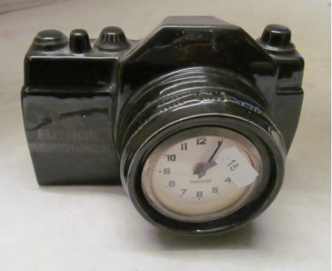 A clock in the form of a camera
