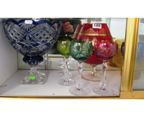 A blue glass bowl, five glasses, red glass large goblet/vase, glass bowl and ladle and other glass