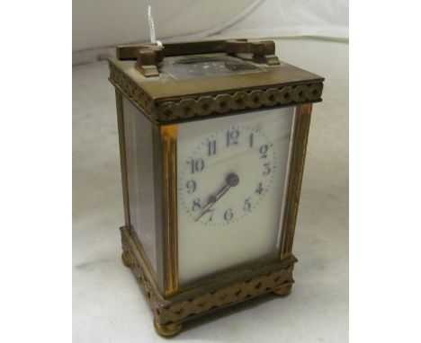 A brass carriage clock with basket weave border
