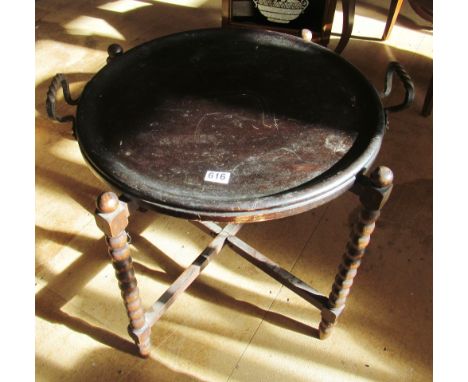 A 1920s tray top table on bobbin turned folding stand