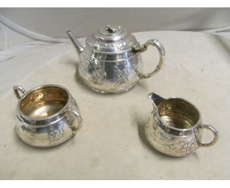 A Victorian silver three piece teaset decorated leaves and berries, dragonfly finial to teapot and slight dents to all three 