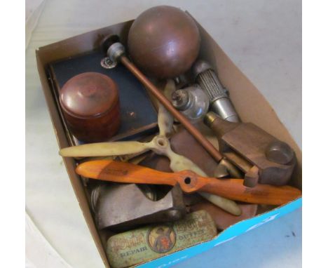A small group of tools, small propellers, cigarette cards etc