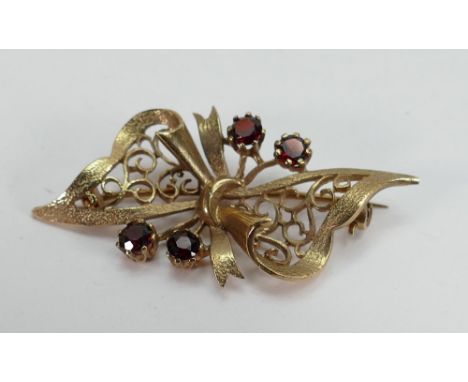 9ct gold ornate bow brooch: set with semi precious stones and hallmarked for Birmingham 1976 with makers mark GR, 7g. 