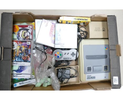 A collection of Nintendo items to include: Super Nintendo Game System, 8 DS boxed games, gun accessories etc 