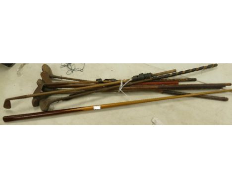 A collection of eight Hickory shafted Golf Clubs including: Drivers,woods  and irons, together with a vintage Snooker Cue.