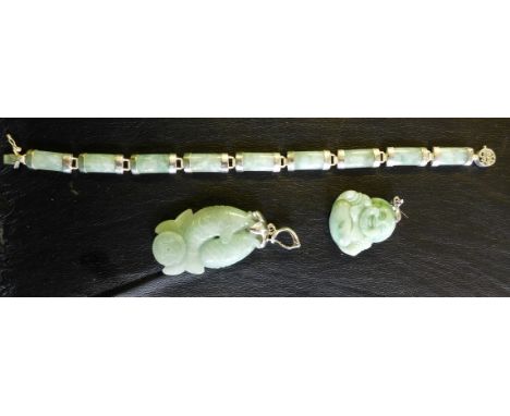 A jade and white metal bracelet, together with, a carved jade Buddha pendant and a carved jade double carp pendant (3)