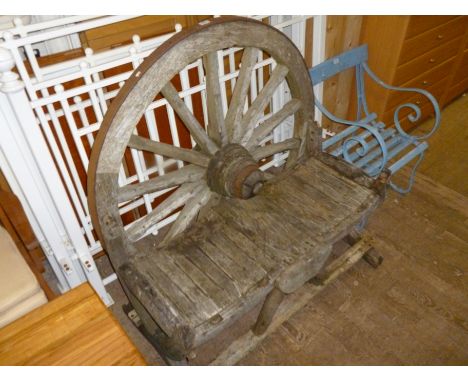 An unusual and decorative garden bench in the form a wooden wagon wheel, nicely weathered and aged.