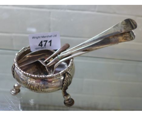 A London hallmarked silver circular open salt raised on three hoof feet, a Georgian silver caddy spoon modelled in the form o
