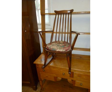 An Ercol stick back rocking armchair.