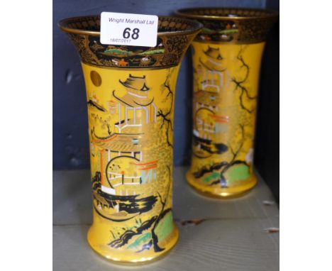 A pair of Carltonware sleeve vases decorated in the 'New Mikado' pattern on a mustard ground, black factory marks to base, he