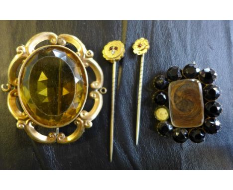 A mourning brooch, to a faceted jet surround, together with, a orange paste and gilt metal brooch, and two gem-set stick pins