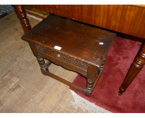 A reproduction Period-style carved oak lamp table, with single frieze drawer.