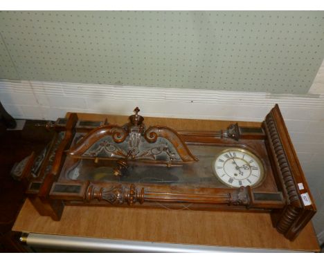A 19th Century continental carved walnut cased Vienna type wall clock, of ornate architectural form, in need some attention.