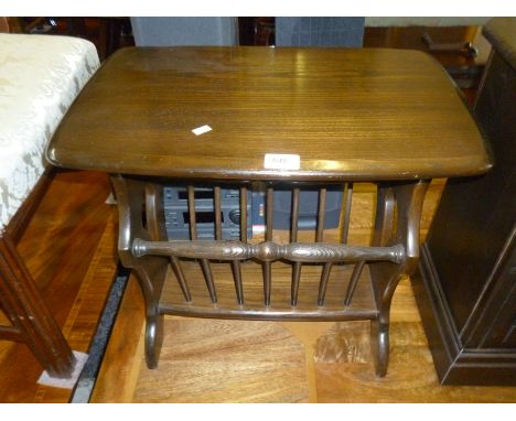 An Ercol dark elm finished magazine rack.