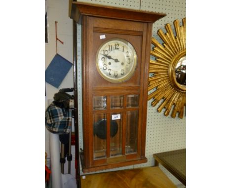 An early 20th Century glazed oak framed wall clock, bearing presentation plaque dated October 26th 1912.