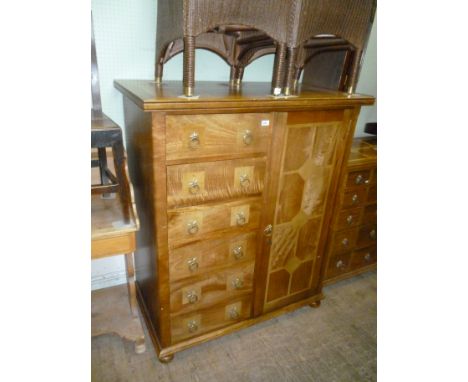 A good quality solidly built Flagstone side cabinet, the intricate inlaid top above one full length door flanked by six drawe