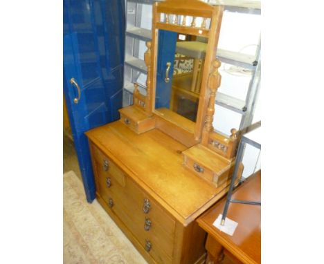 A late 19th Century stripped pine dressing chest with swing mirror and two trinket drawers, above two short and two long draw