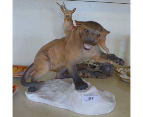 A Beswick pottery matt model of a Panther poised on a rock, together with a Beswick stag