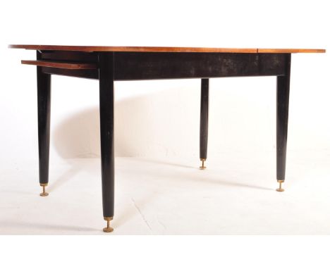 A retro vintage mid 20th century G Plan Librenza extendable dining table having a teak table top raised on ebonised tapering 