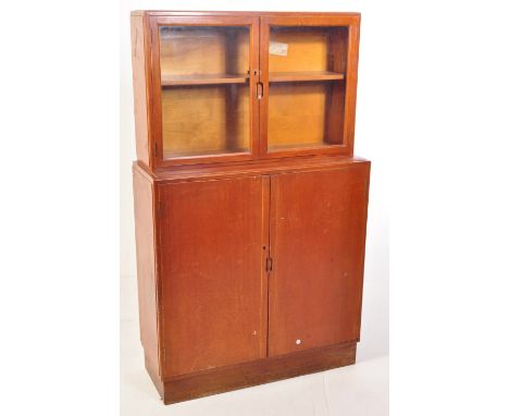 A vintage mid 20th century circa 1950s oak air ministry style library bookcase cabinet having a glazed double door cabinet at