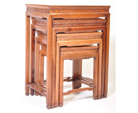 A set of vintage 20th century oak nest of tables of graduating form having carved border to tabletop with&nbsp; 'dot and dash
