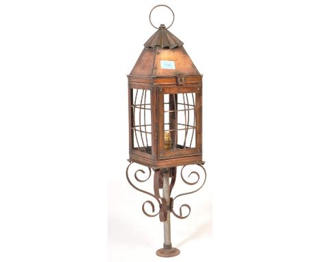 A vintage copper 20th Century porch light / lantern. The light having a loop at the top, the light housed in a wire cage that
