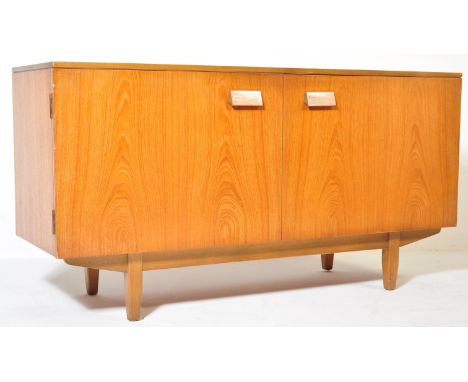 A retro vintage mid 20th century teak wood side board credenza having angular recessed handles two the double door cabinet op