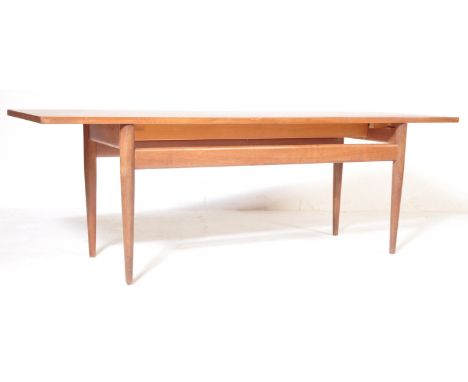 A retro vintage mid 20th century Danish inspired teak wood coffee table of rectangular form raised on upright supports. Measu