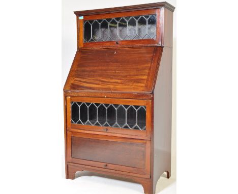 A Victorian 19th century mahogany art nouveau inspired bureau bookcase. The bookcase having a leaded glazed cabinet atop of a