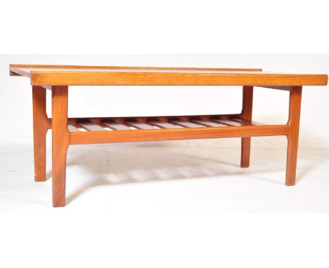 A vintage retro mid 20th century teak coffee table having a rail magazine rack under tier.&nbsp;Measures approx: 45cm x 111cm