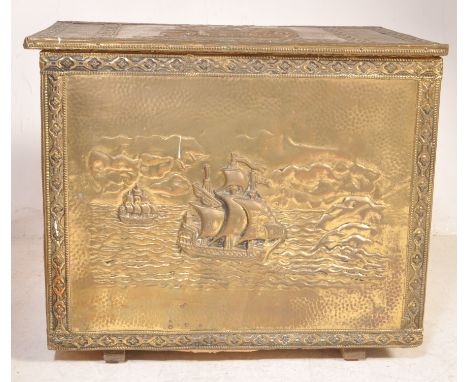 A vintage 20th century coalbox / purdonium of cuboid form having a brass covering with raised decorationof a ship on the sea.