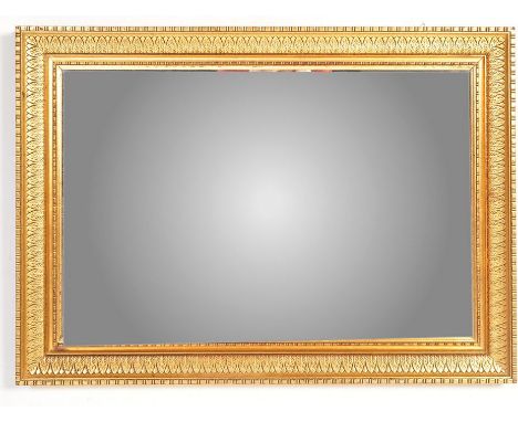 A large vintage 20th century wall mirror of rectangular form with fluted mahogany framed and bevelled edge to the mirror.&nbs