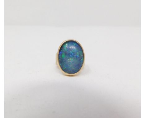 A vintage black opal triplet 9ct gold gentlemans ring. Set with an oval black opal triplet with a height of 2 cm. The taperin