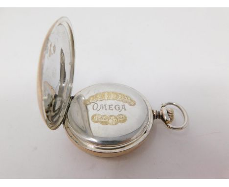 A vintage omega silver pocket watch. The case is silver and there are continental hallmarks inside the case backs, together w