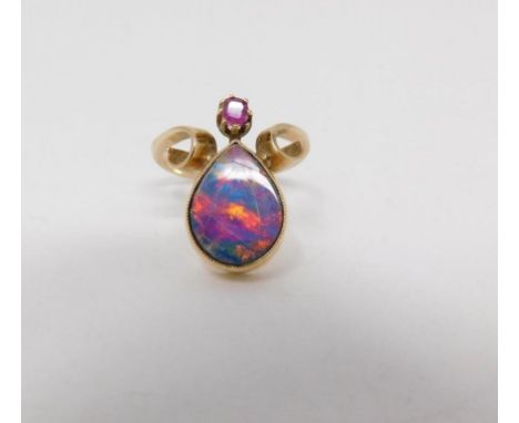 A Black Opal doublet Art Nouveau style ring, set with a drop shape Black Opal doublet and a cushion shape mixed cut ruby with