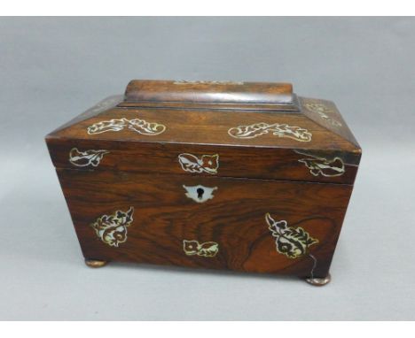 Rosewood and mother of pearl inlaid sarcophagus tea caddy, the hinged lid opening to reveal two lead lined divisions, 22 x 15