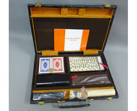 Games compendium with backgammon and draughts, etc contained within a black leather case 