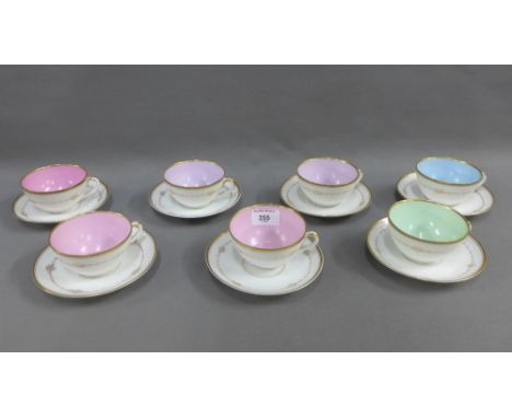 Set of seven white glazed porcelain cups and saucers each with a pale coloured interior (a lot) 