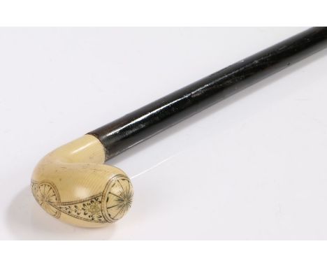 Scrimshaw handled walking stick, the ivory head with engraved roundel and foliate decoration above a tapering ebonised stick 