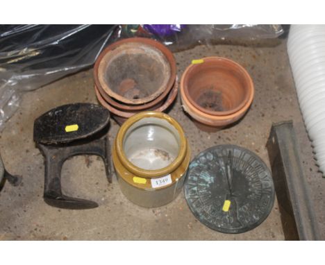 A quantity of terracotta plant pots, a cast iron shoe last, glazed stoneware pot and a sundial