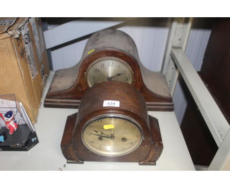 An oak cased two hole mantel clock and an oak cased three hole mantel clock