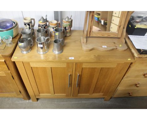 A modern light oak two door sideboard