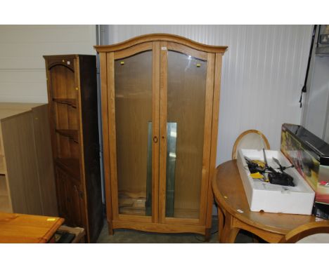 A modern light oak and glazed display cabinet