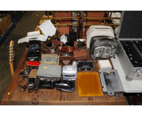 A quantity of various cameras and accessories to include Polaroid; Canon; Halina etc