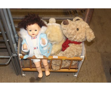 A child's dolls cot and doll with two teddy bears