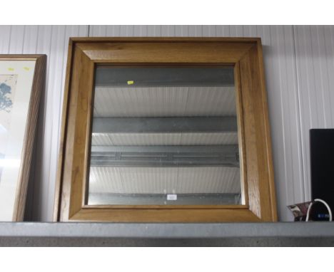 A modern light oak framed mirror