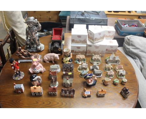 A quantity of various model cottages including Felsham pottery cottages, Lilliput lane some with original boxes, Wade piggy b