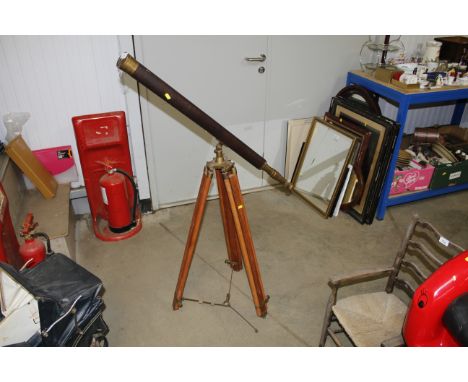 A brass and leather coloured telescope on tripod stand