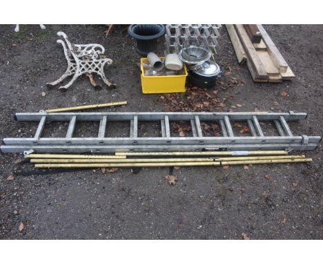 An aluminium double extending ladder with support legs